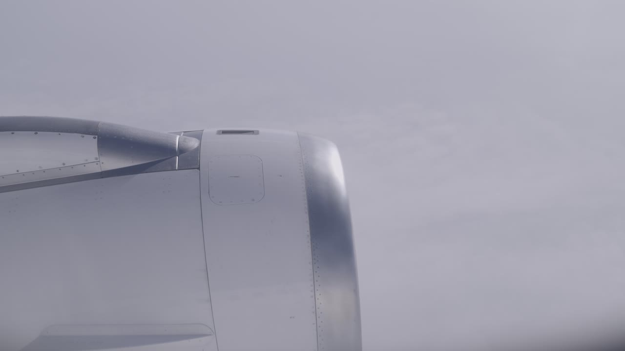 Airplane engine in-flight view with cloudy sky in the background