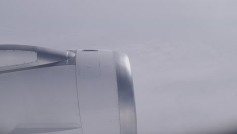 airplane engine in-flight view with cloudy sky in the background