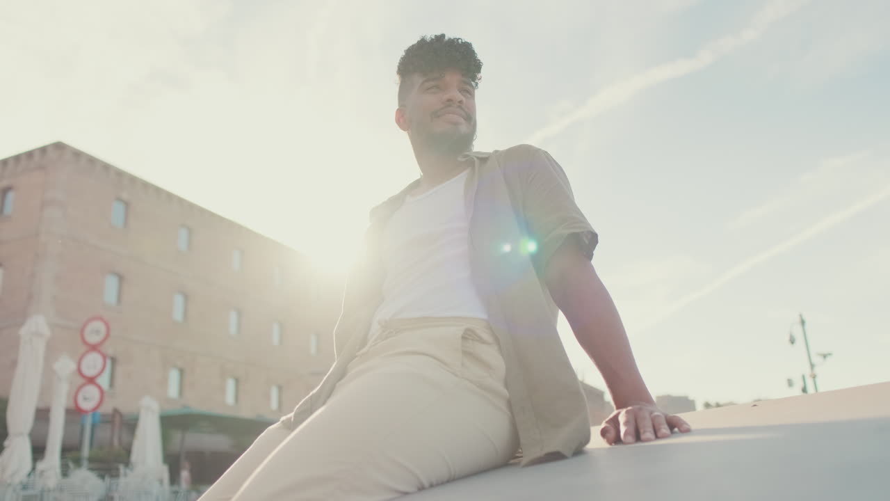 Man sitting outdoors in urban setting