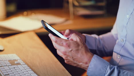 closeup of a business man at night texting