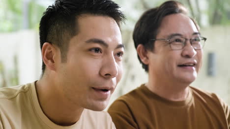 Senior-and-young-asian-men-in-the-living-room