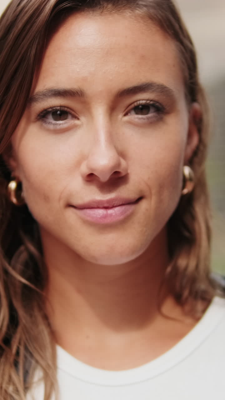 Close-up of European young woman, pretty female studet smiling outdoors with