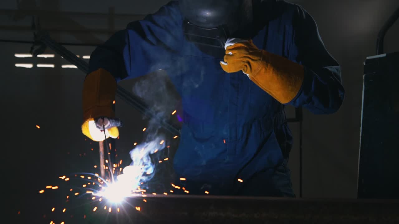 Metal welder working with arc welding machine