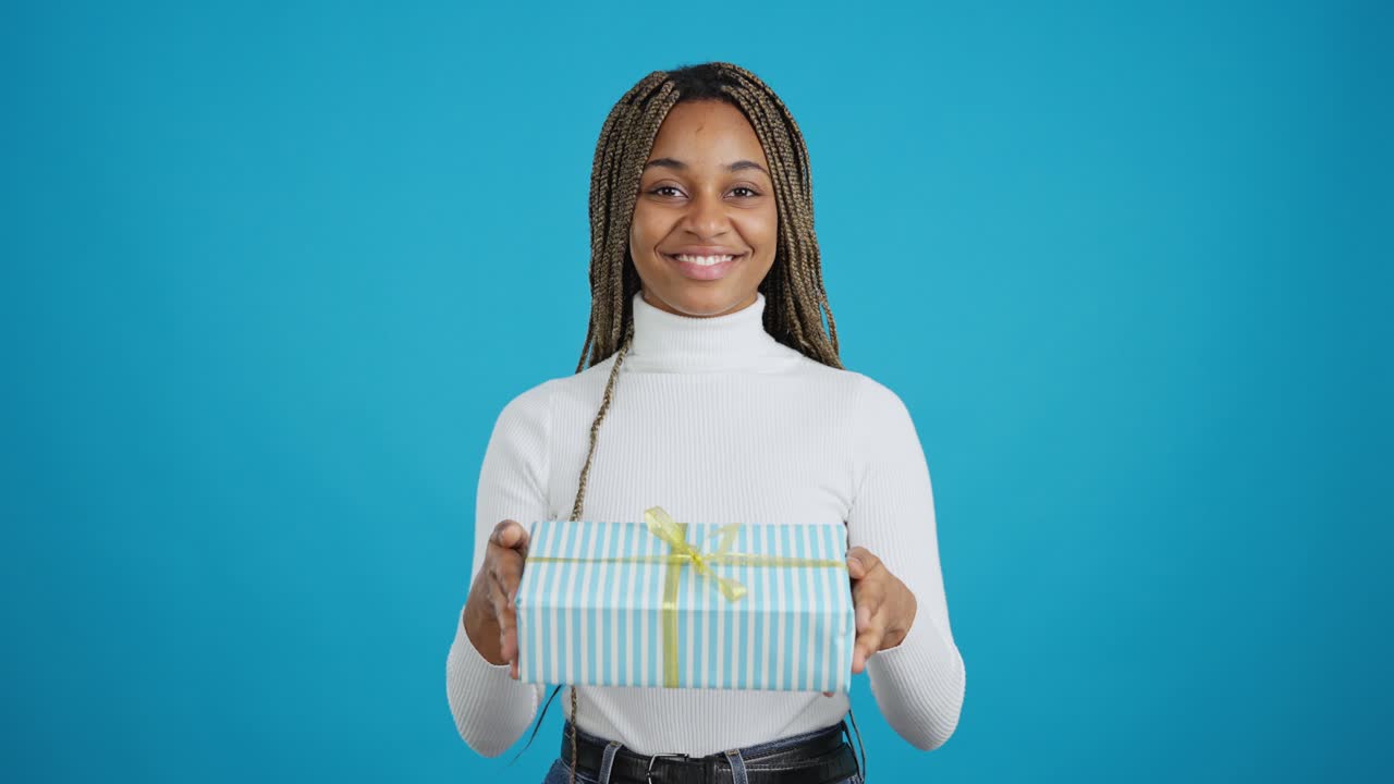Young woman offering a gift box
