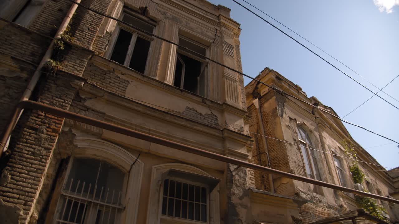 Tbilisi Georgia Dzveli area with old houses that were built in 19th century. Blue sky and clouds.
