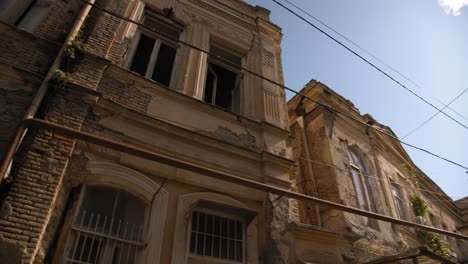 Tbilisi Georgia Dzveli area with old houses that were built in 19th century. Blue sky and clouds.
