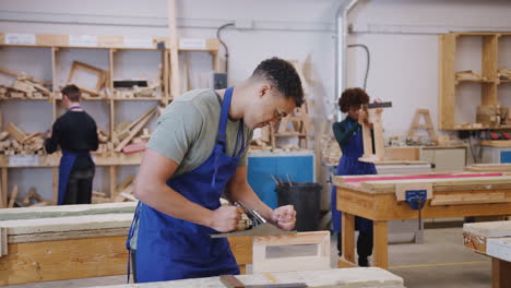 Wide-Angle-View-Of-Carpentry-Workshop-With-Students-Studying-For-Apprenticeship-At-College