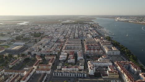 aerial arc over portuguese city on guadiana river, vila real de santo antonio