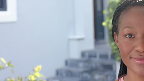 Half-portrait-of-happy-african-american-woman-smiling-in-sunny-garden,-copy-space,-slow-motion