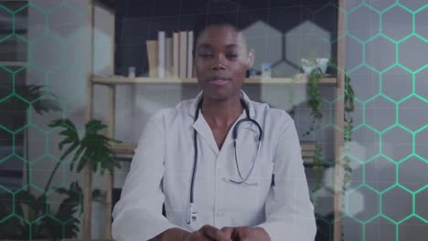 animation of network of hexagons over african american female doctor