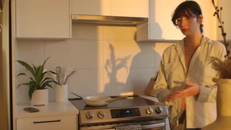 pregnant woman working in the kitchen in the evening sunlight static