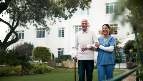 caregiver assisting elderly man in a garden