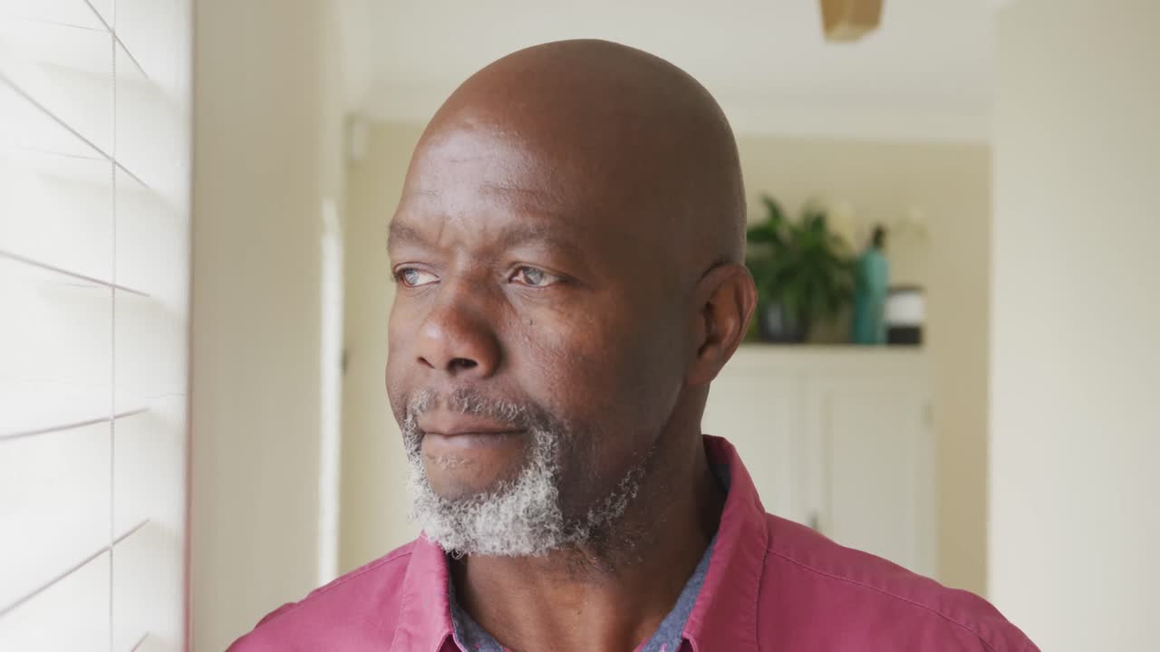Senior african american man looking through window