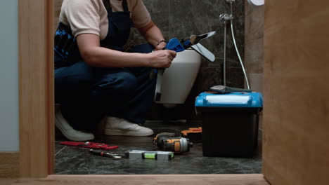 plumber tightening the faucet