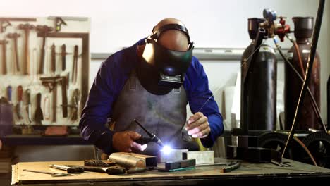 male welder working on a piece of metal