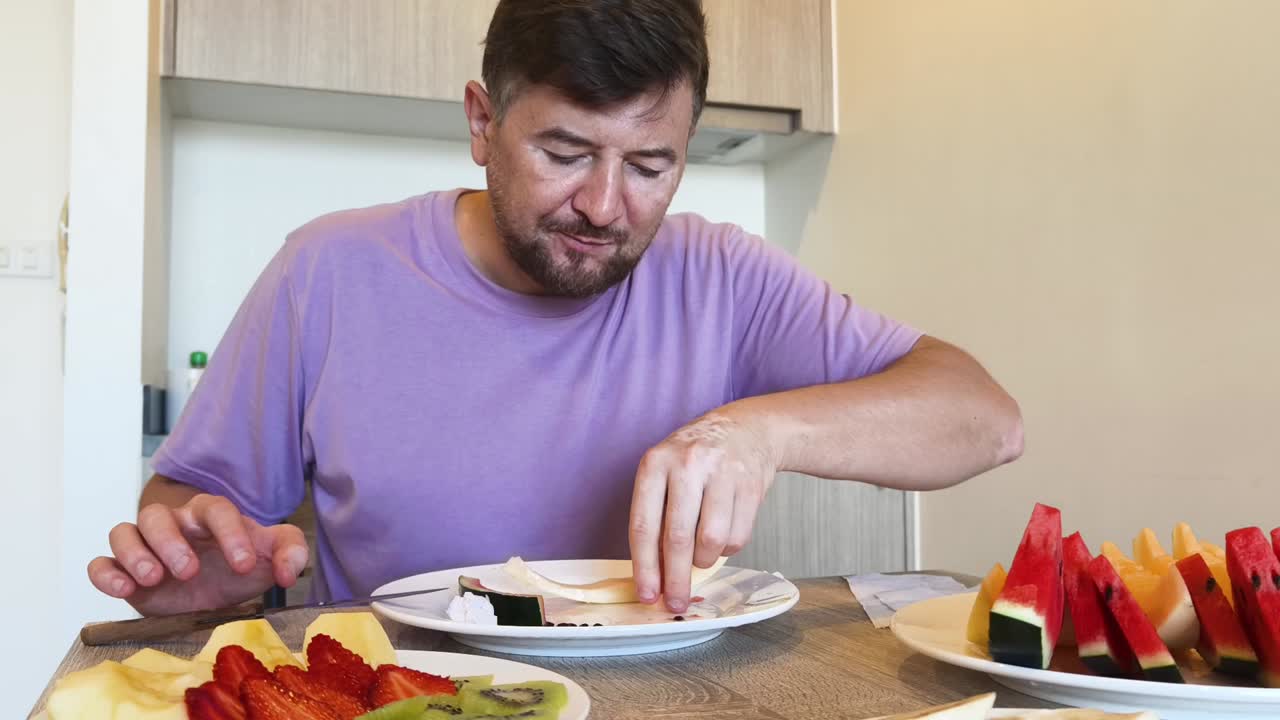 Man Cutting Watermelon and Eating Fruit