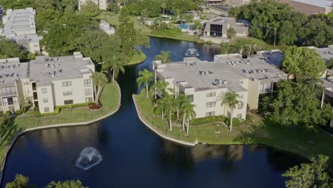 drone 4k daytime flyover of condominiums with lakes and pools