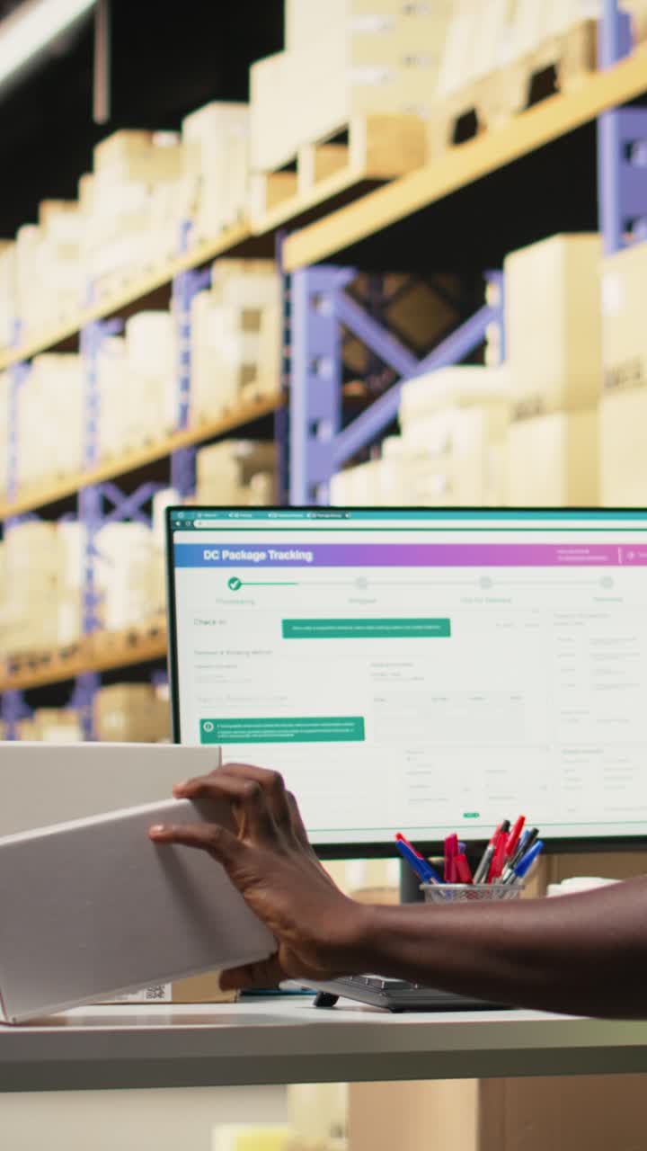 Vertical Video Warehouse employee registering orders with tracking info on airway bill tags