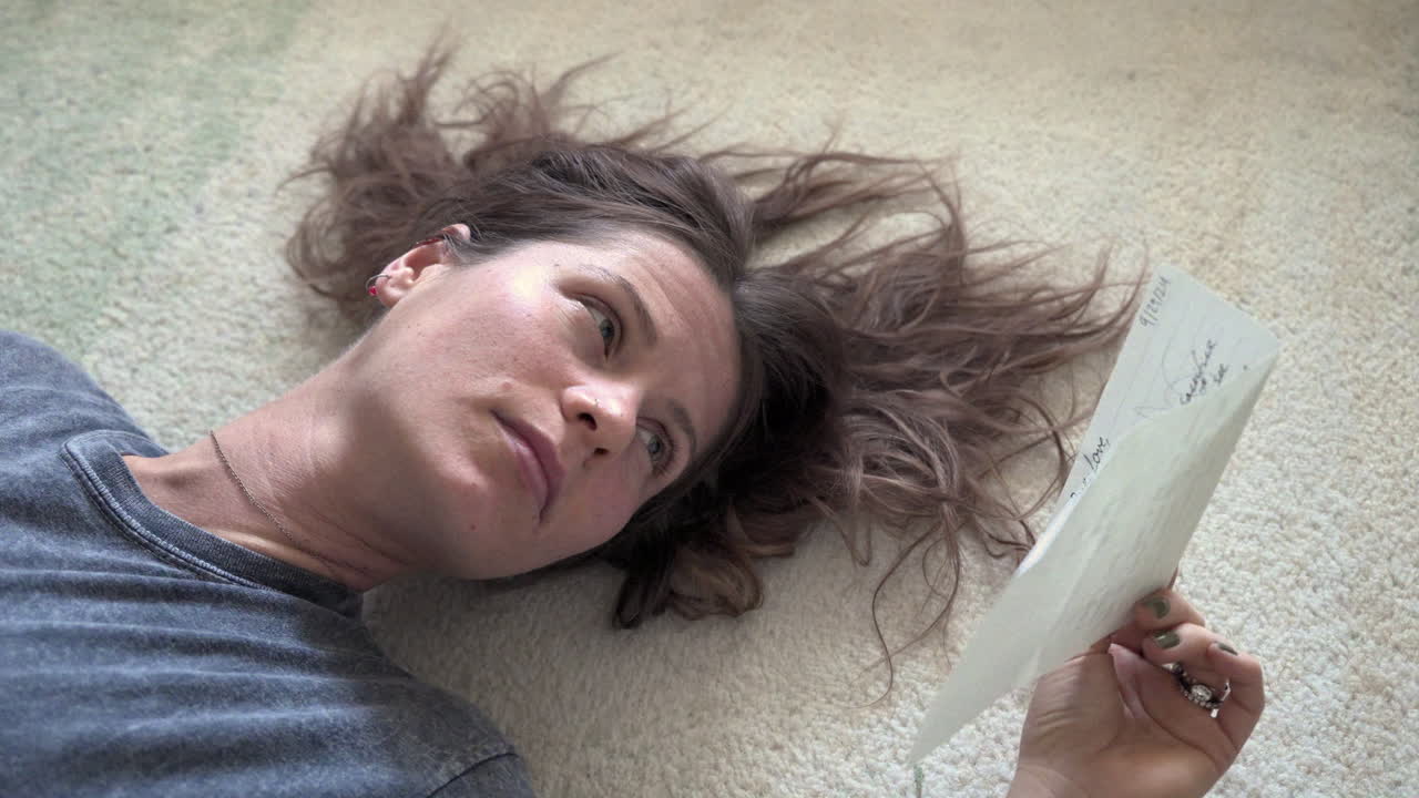 Woman Lying on the Floor Reading a Letter