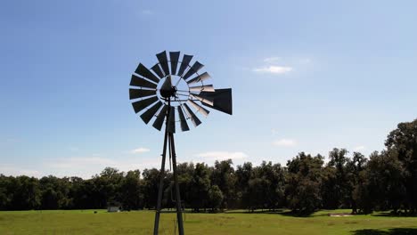 drone footage of a rural windmill windpump in an agricultural setting