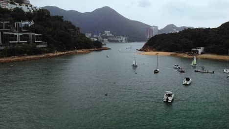 Wide-angle-Drone-Flying-Past-Sailboats-near-Middle-Island