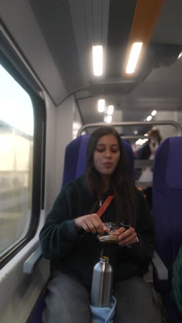woman eating snack on a train