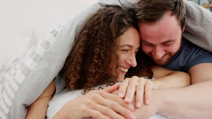 Love, laugh and bedroom with a couple in bed