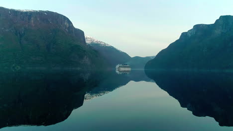 ship over stiil water with mirror reflection in flam village near aurlandsfjord in southwestern norway