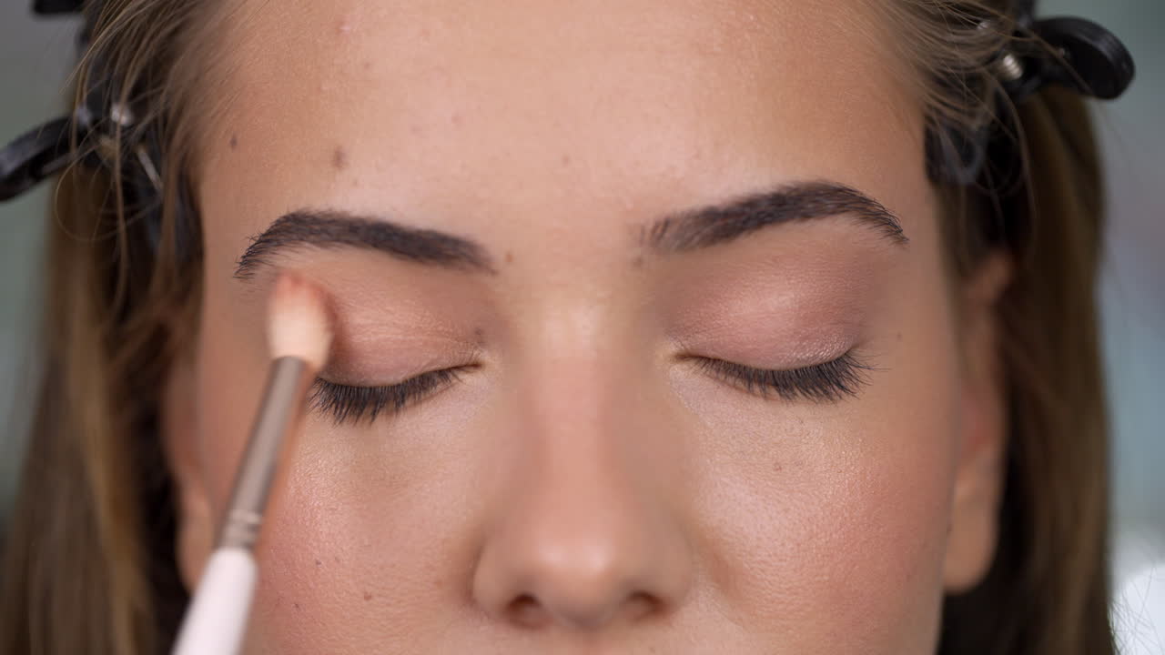 Close-up of a woman applying eyeshadow