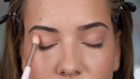 close-up of a woman applying eyeshadow