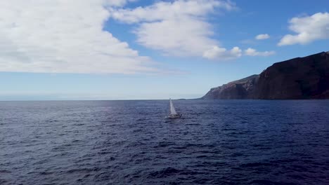 lonely sail boat on blue ocean seascape in los gigantes is a resort town in the santiago del teide tenerife canary island aerial view