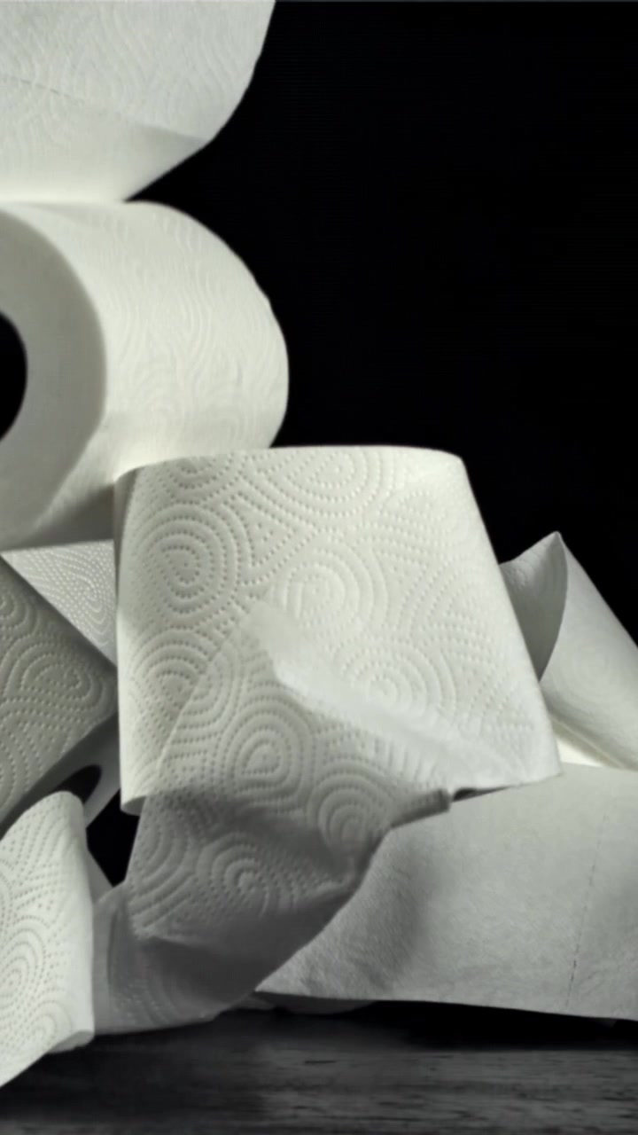 White Paper Towel Rolls Falling and Unrolling in Slow Motion