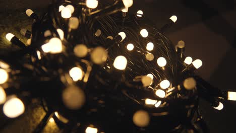 Close-up shot hank of christmas garland with golden lights on a playd. Christmas concept. Home decor