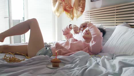 Woman-celebrating-her-birthday-in-bed