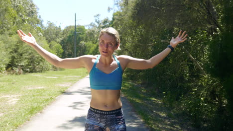 fit muscular blonde female athlete happily raising arms celebrating race, 4k slow motion