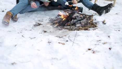 Caucasian-couple-camping-in-a-snowed-forest.