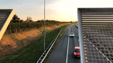 Highway-with-moving-cars-at-sunset