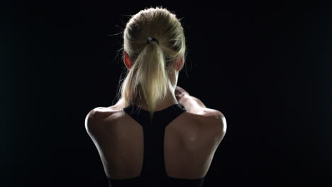 back view of sport woman training stretch exercise in gym. fit girl warming up