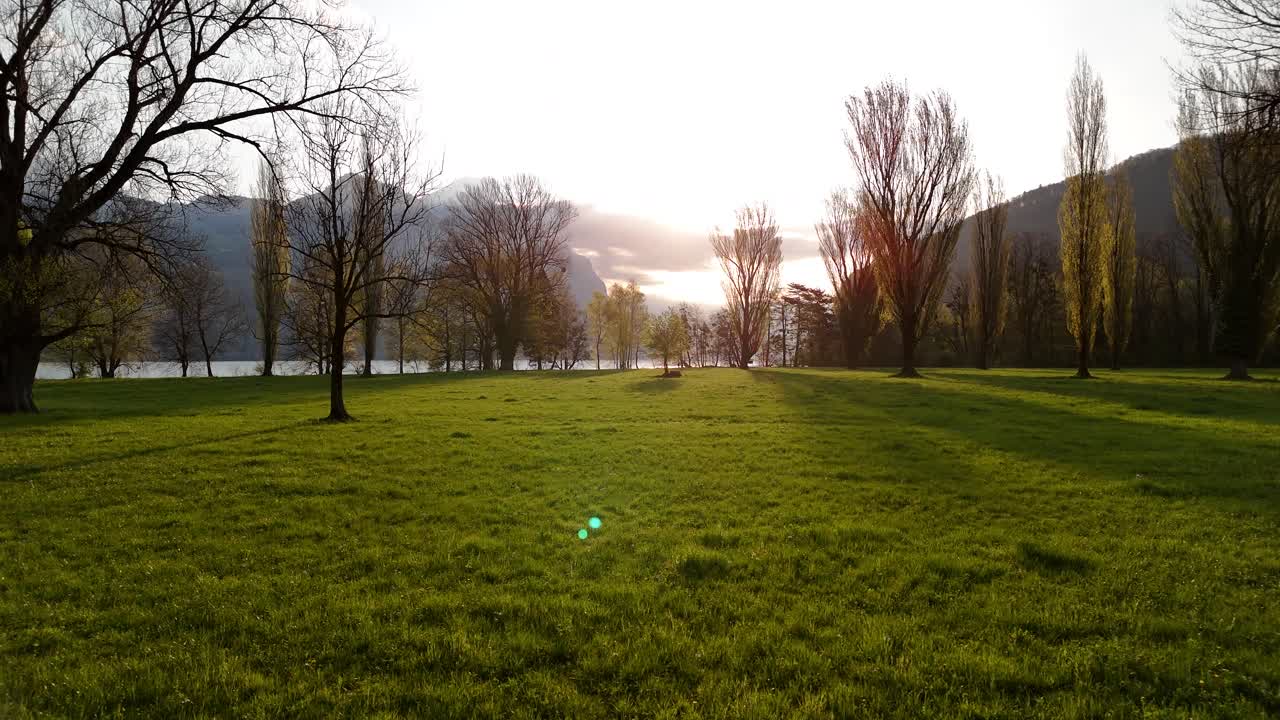 Serene sunrise outdoor over Walensee lake water, walking towards sun rays