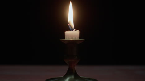 a candle burs out in the dark room