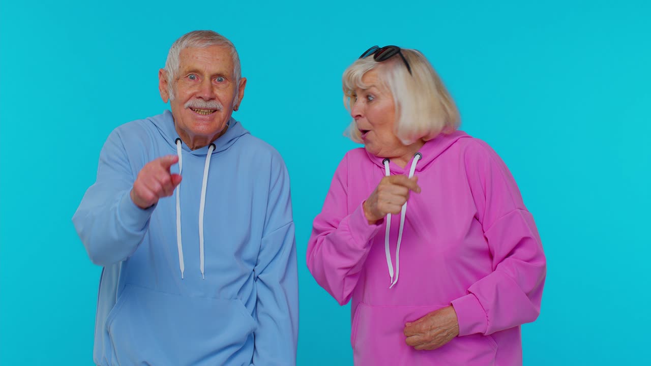 Senior stylish grandparents pensioners showing thumbs up, nodding in approval, successful good work