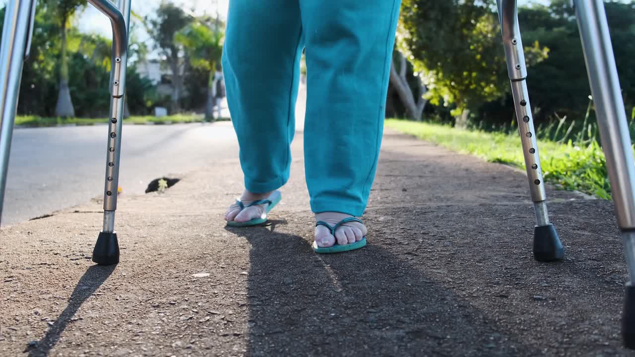 Person walking with crutches on the street