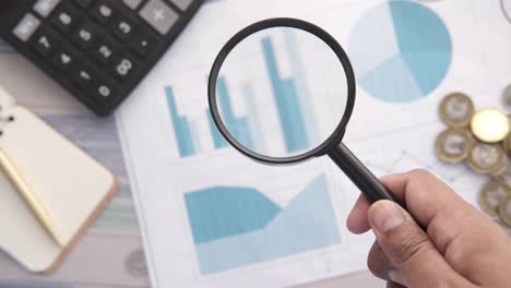 analyzing financial data with magnifying glass