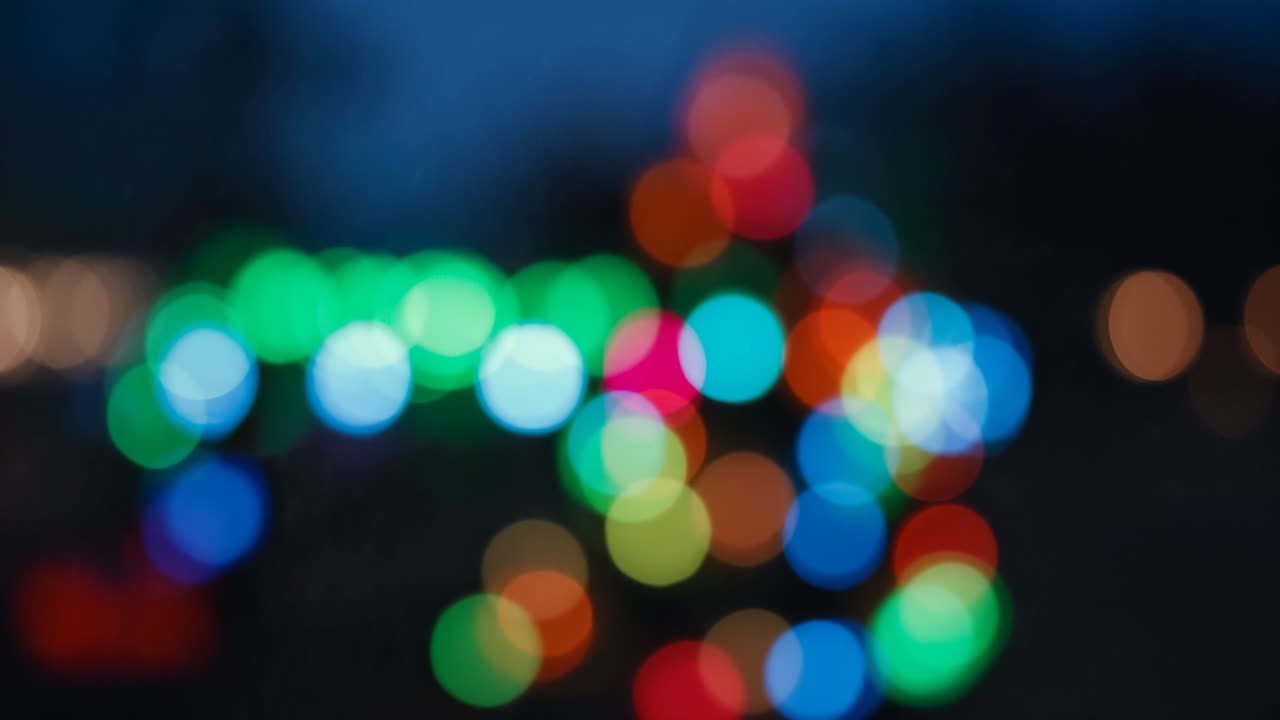 Recording camera capturing colorful blurred LED light circles at twilight, creating ambient mood