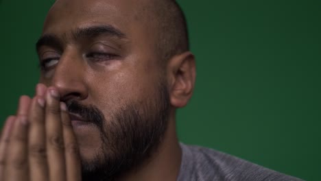 male sitting with slow clapping hands rocking back and forth