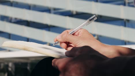 person writing in notebook