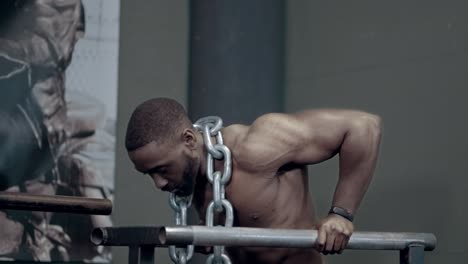 athletic african american performing weighted dips