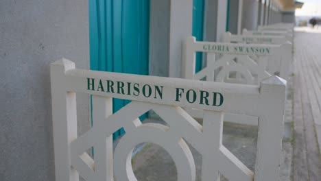 Hollywood-Actor-Harrison-Ford's-Name-At-The-Seaside-Beach-Huts-And-Wooden-Promenade-In-Deauville,-Normandy-France