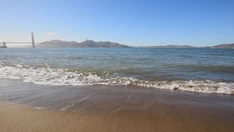 Blick-Auf-Die-Wellen,-Die-Im-Crissy-Feld-Rollen,-Mit-Der-Golden-Gate-Bridge-Im-Hintergrund