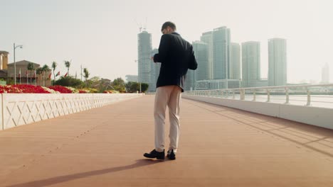 businessman dancing on a city bridge